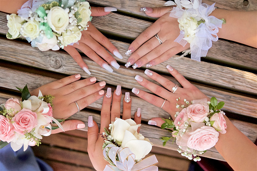 Decorative manicure on nails with wrist flower corsages