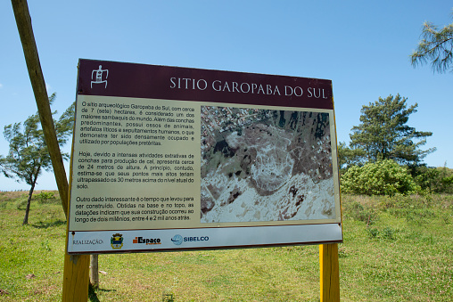 Jaguaruna, Santa Catarina, Brazil - November 20, 2019: Image with the placard with the information about the site Sítio arqueológico Ponta da Garopaba do Sul, in Santa Catarina state - Brasil