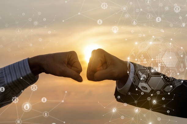 istock Businessmen greet each other with fists . 1254814799