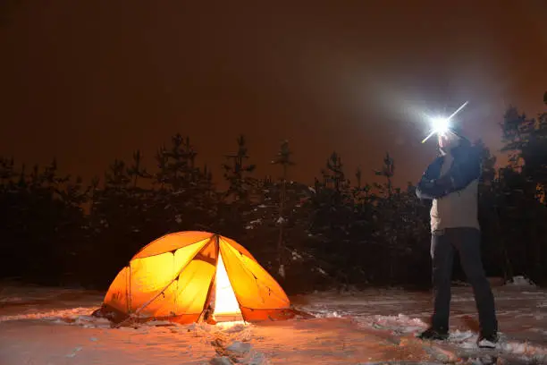 tourist pitched a tent for spending the night in the winter forest