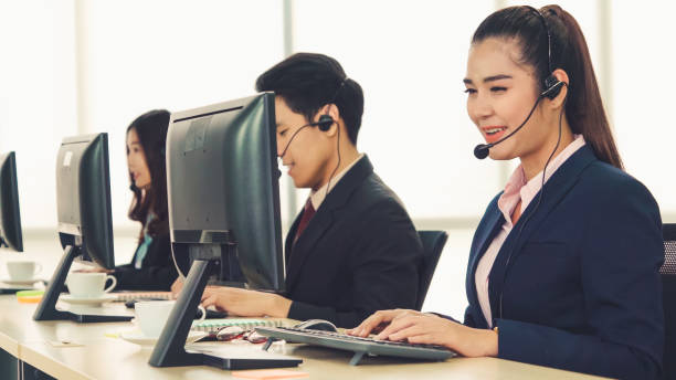 istock Business people wearing headset working in office 1254816124