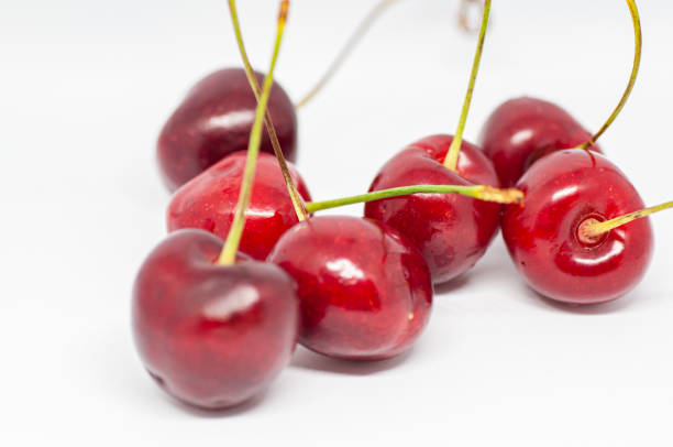 istock Macrophotography of cherry berries isolated on white background 1254817433