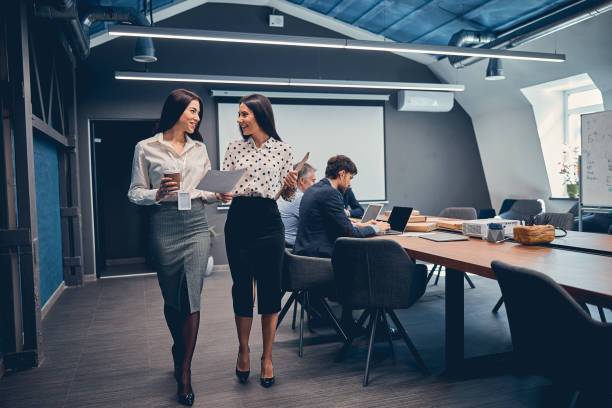 istock Business partner standing in company and discussing about some paper work 1254817541
