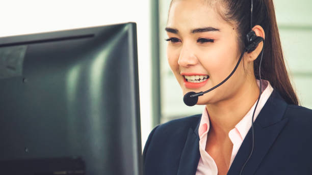 istock Business people wearing headset working in office 1254817614