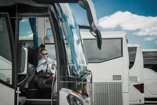 Photo of Bus Driver Pointing At Wrist Watch.