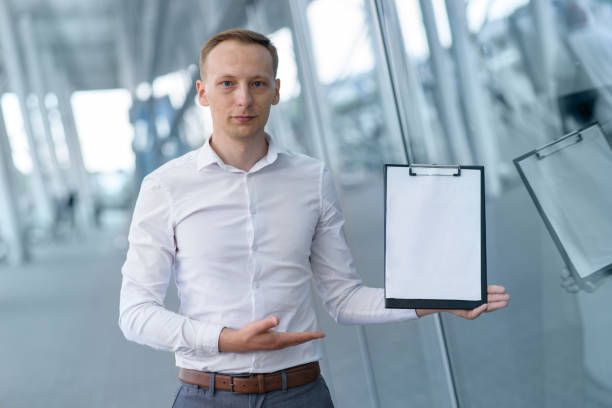 istock Young businessman shows your text on a tablet. 1254819094