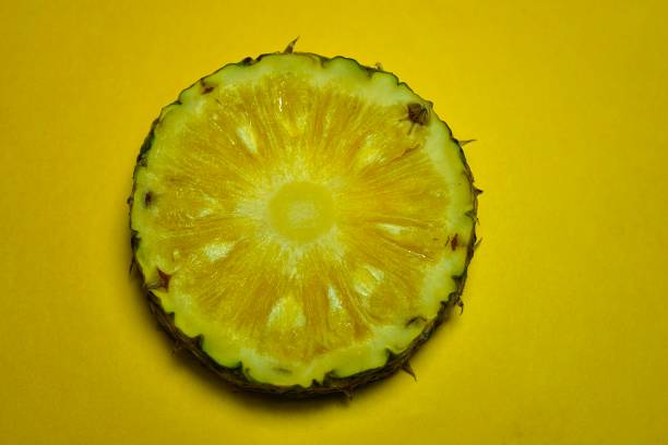 istock pineapple slices isolated on yellow background with copy space 1254821190