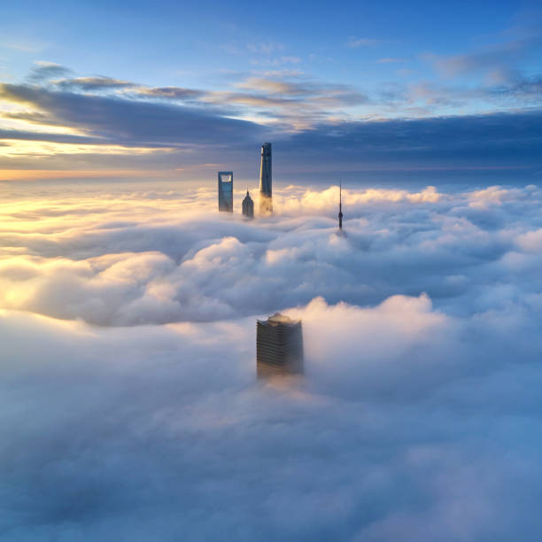 Aerial View of Shanghai Skyline on Thick Cloud, China Aerial view of Shanghai skyline on thick cloud at morning, China. above cloud stock pictures, royalty-free photos & images