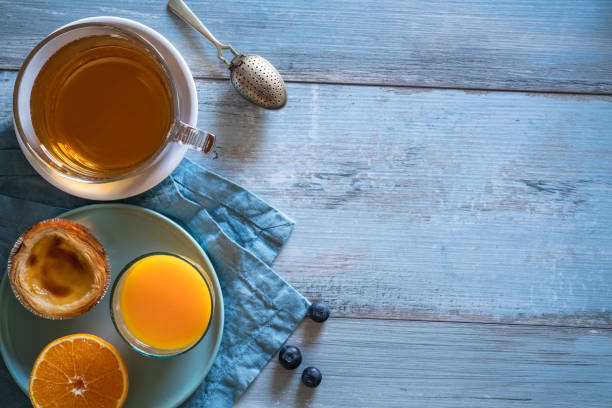 istock Breakfast Tea cup with Portuguese egg tart with orange juice 1254822356