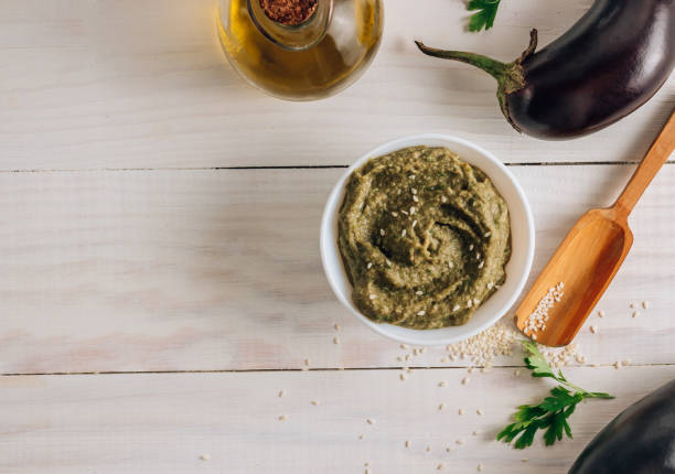 istock Traditional arabian eggplant dip baba ganoush on white wooden table 1254822913