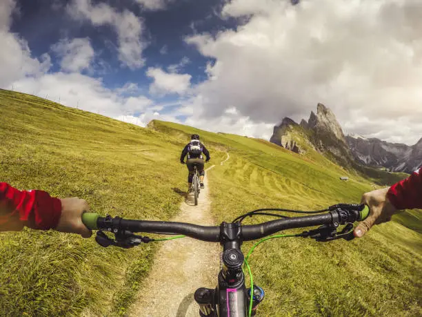 Point of view POV pedaling on mountain bike on the Dolomites