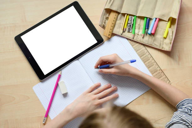 Online home lesson. Blank for your text. Children's hands in the frame. School supplies. Social distance.