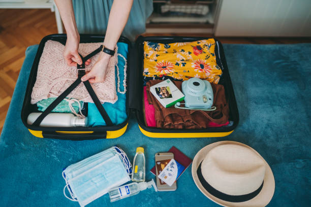 istock Suitcase packing for travel during COVID-19 1254825437