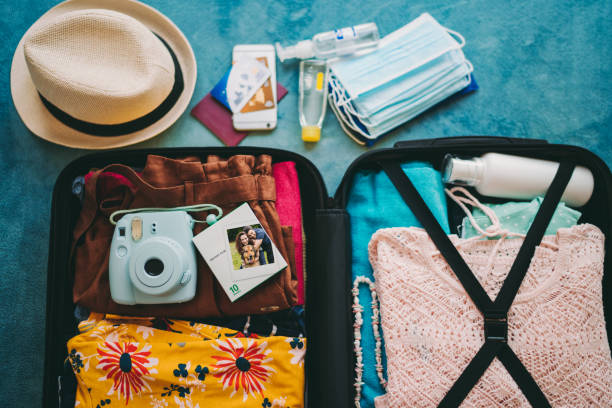 istock Packed suitcase for travel, COVID-19 concept 1254825844