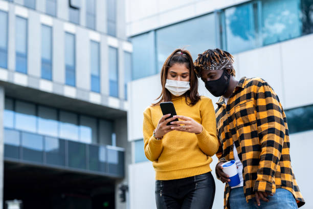 istock Latino friends check their mobile phone 1254826017