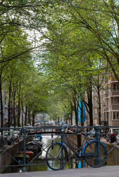 Bicycle parked near a canal in Amsterdam, Netherlands
