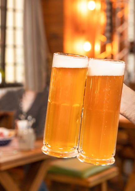 istock Holding two beer drink mug, glass with one hand 1254828340