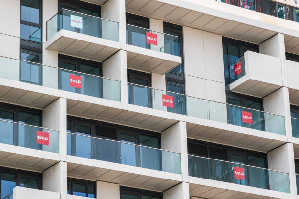 Brand new empty apartments with sold and available signs in London Brand new empty apartments with sold and available signs around Finsbury Park in London cladding construction equipment photos stock pictures, royalty-free photos & images