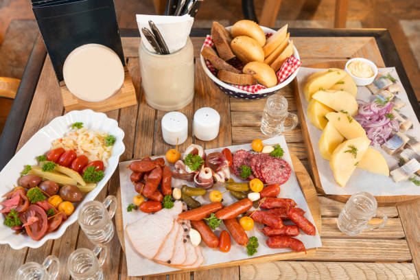 istock Sausage with cheese and fermented cucumbers, snacks with vodka on the table 1254829211