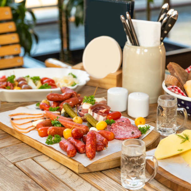istock Sausage with cheese and fermented cucumbers, snacks with vodka on the table 1254829477