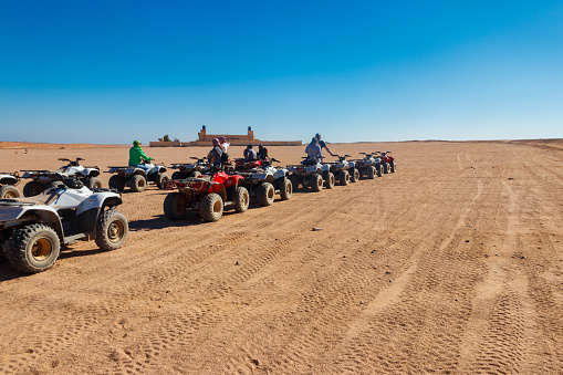 Hurghada, Egypt - December 10, 2018: Safari trip through egyptian desert driving ATV. Quad bikes safari in the desert near Hurghada, Egypt