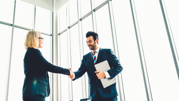 istock Business people handshake in corporate office 1254829854