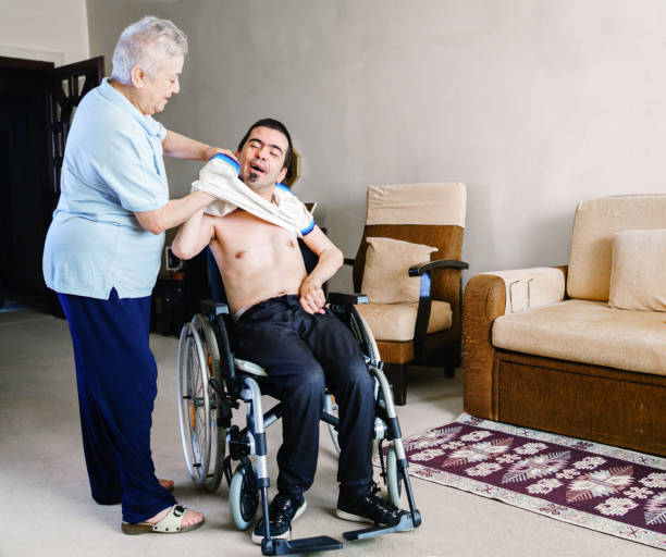 istock Serious disabled young man at home 1254831523