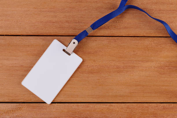 istock Blank Identification Card with Neckband on Wooden Background 1254831650