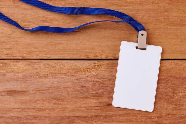 istock Blank Identification Card with Neckband on Wooden Background 1254831699