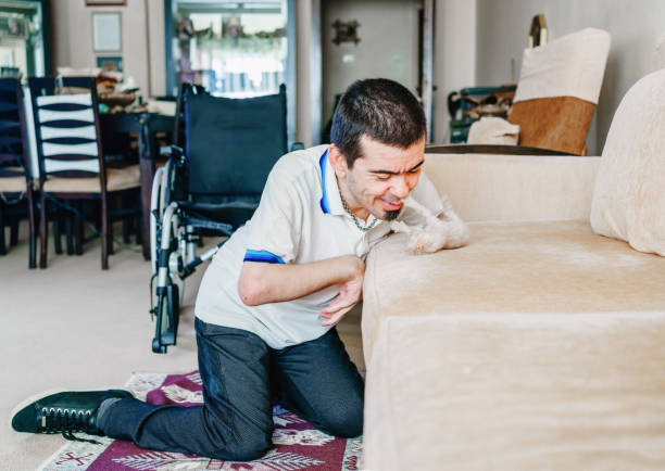 Serious disabled young man at home Serious disabled young man at home animal therapy stock pictures, royalty-free photos & images