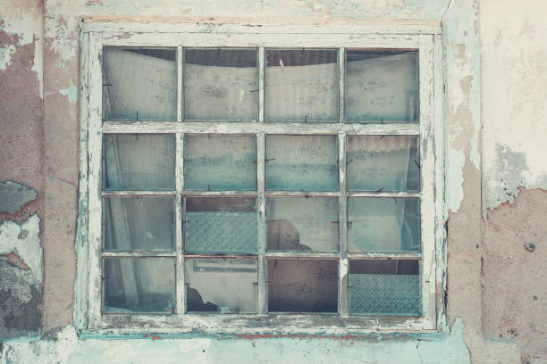 istock Old window in a ruined house, close-up. Retro style 1254832315