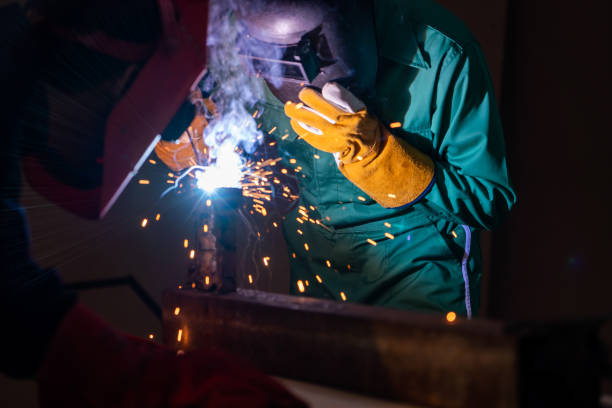 istock Metal welding steel works using electric arc welding machine 1254833208
