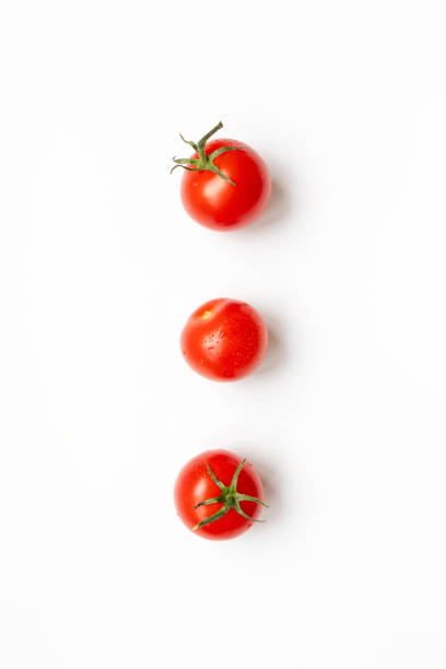 istock Fresh cherry tomatoes on a white background , flat lay. Raw food and vegetable concept 1254835826