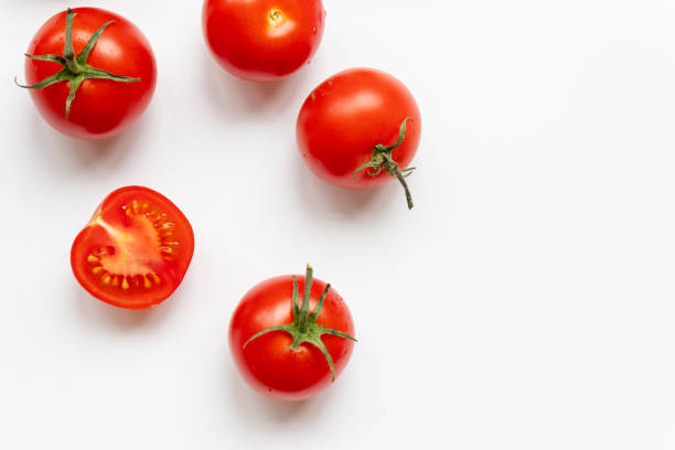 istock A lot of fresh cherry tomatoes randomly scattered on a white background 1254835918