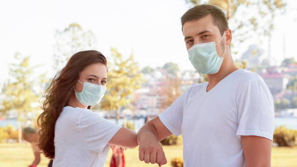 istock High five without hands, People greeting during COVID-19 pandemic 1254835967