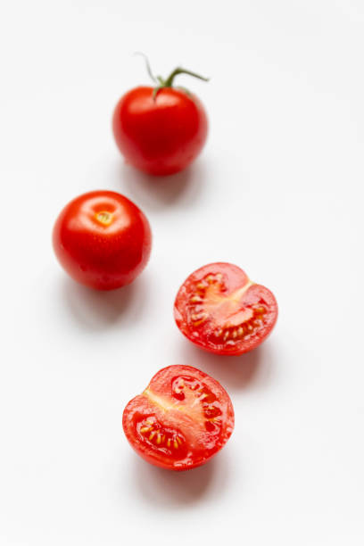 istock Fresh raw tomatoes with water drop isolated on white background, top view, flat lay 1254836004