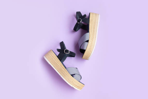 Various women's shoes on a colored background, top view. Top view, flat lay