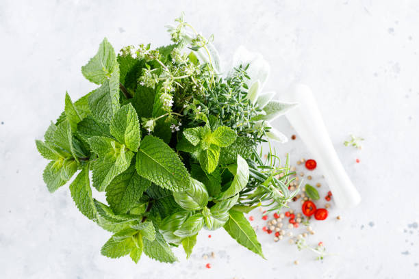 istock Bunch of aromatic herbs in mortar on kitchen table 1254838122