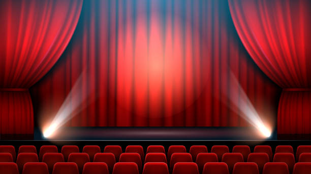 istock Theater show stage interior with red curtain, spotlight and theater chairs 1254838292