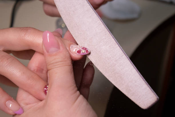 istock the process of doing manicure. beauty concept. Gel polish, shellac. 1254838645