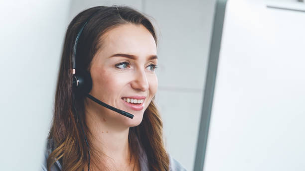 istock Business people wearing headset working in office 1254838917