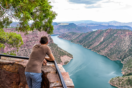 Canyon Rim Campground in Flaming Gorge Utah National Park of Green River high angle aerial overlook viewpoint in evening with man person looking at view