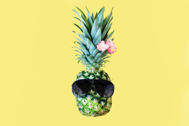istock Funny pineapple with sunglasses on yellow pastel background. Summer background. 1254840306