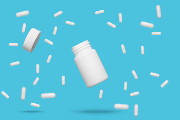 istock Floating white medicine pills and bottle 1254840559