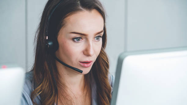 istock Business people wearing headset working in office 1254842242