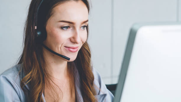 istock Business people wearing headset working in office 1254842516