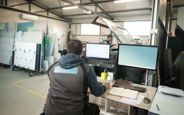 istock Operator analyse status of printing jobs on computer in printshop 1254844172