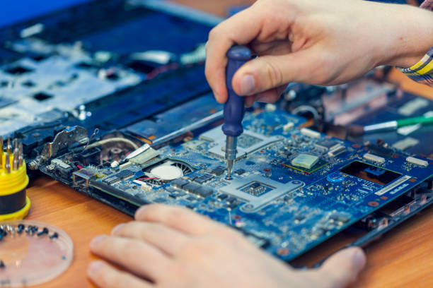 istock the concept of computer hardware, mobile phone, electronic, repairing, upgrade and technology, vacuum cleaning of the cooler from dust, 1254844175