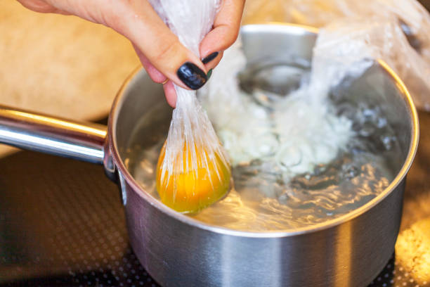 diet breakfast, cooking poached egg in a package, egg poaching in water - poached egg imagens e fotografias de stock