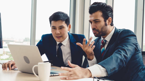 istock Two business people talk project strategy at office 1254844880